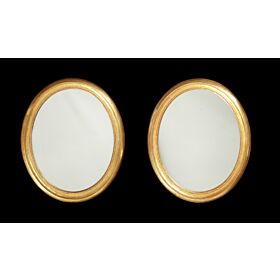 A pair of 19th century oval giltwood mirrors