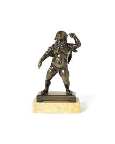 An early 19th century patinated bronze figure of Silenus after the antique