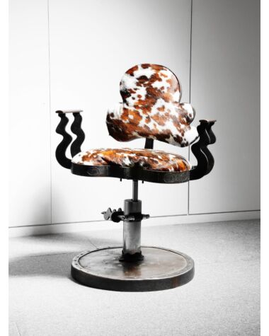 A John Mills  welded steel chair with adjustable seat and cowhide upholstery