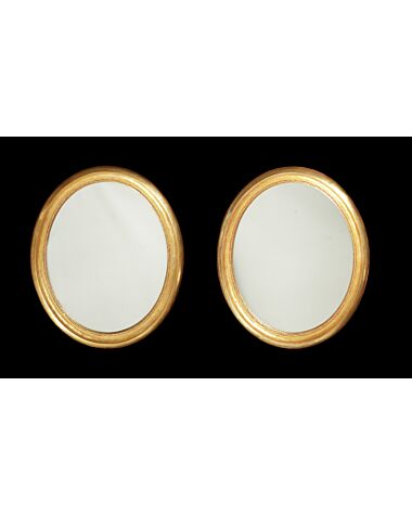 A pair of 19th century oval giltwood mirrors